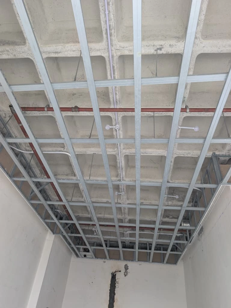 Suspended ceiling framing grid coordinated with building services
